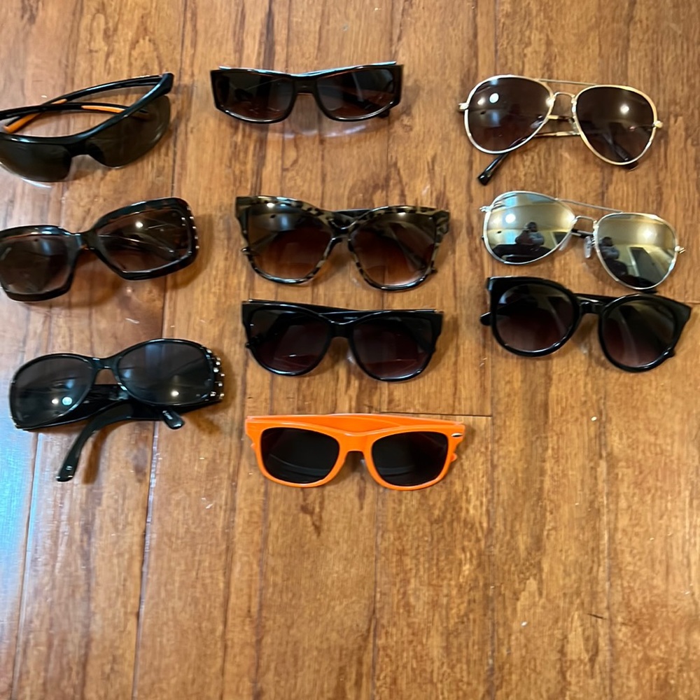 10 pairs of various women and men sunglasses.